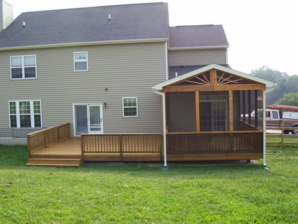 Nevins Construction built this wooden deck with a screen room with a sunburst